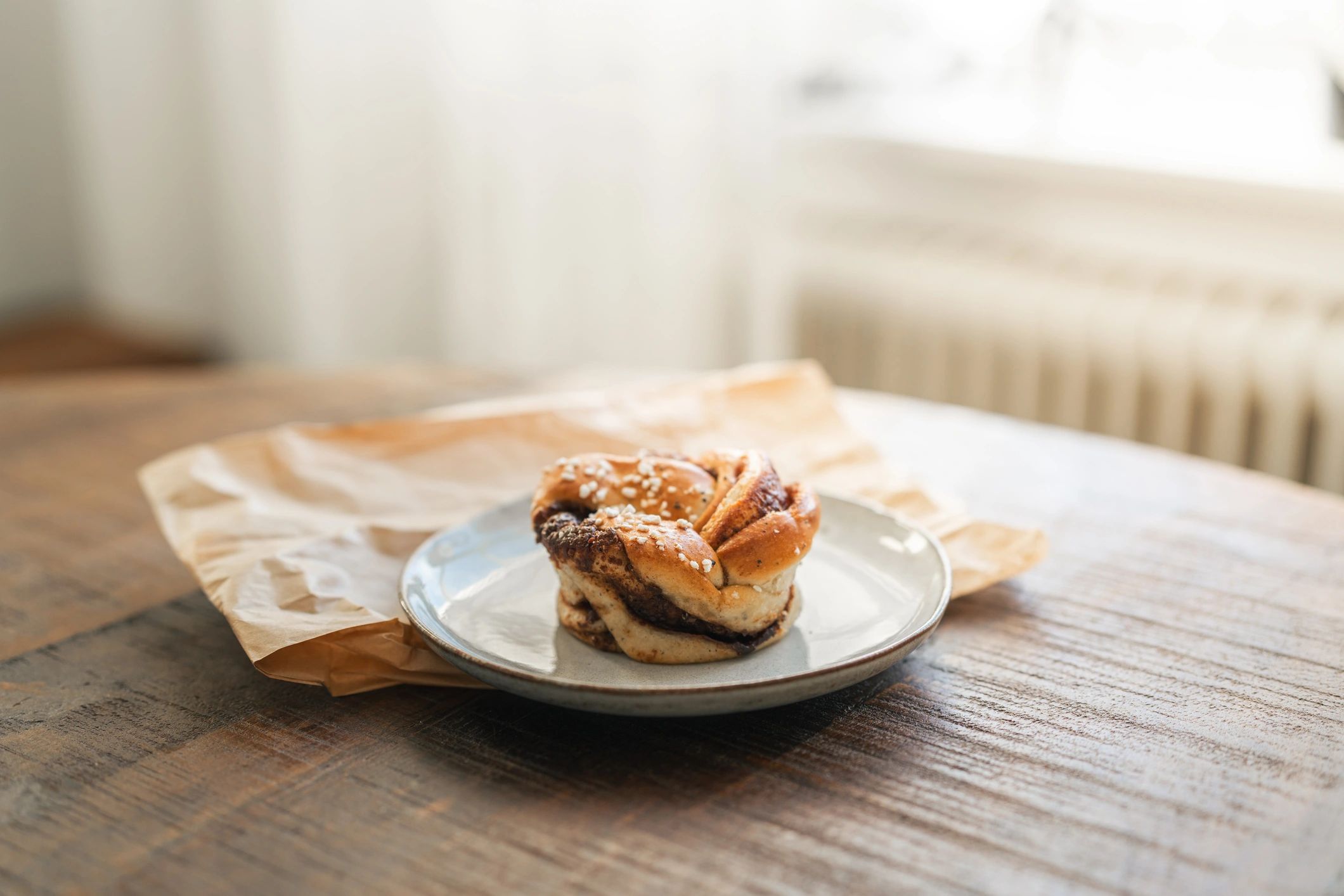 Freshly baked cinnamon bun on a rustic table