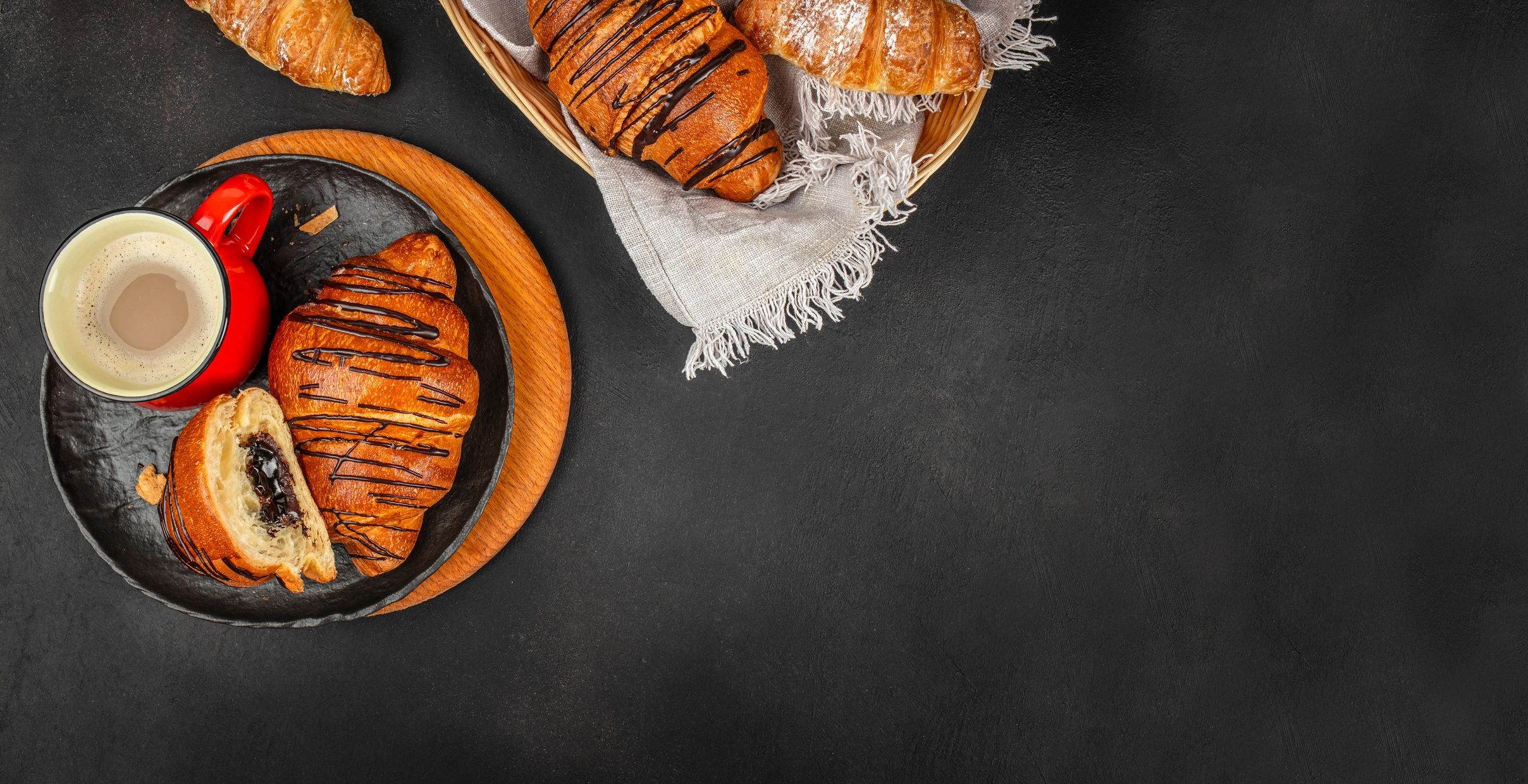 Chocolate croissants and coffee on a dark background