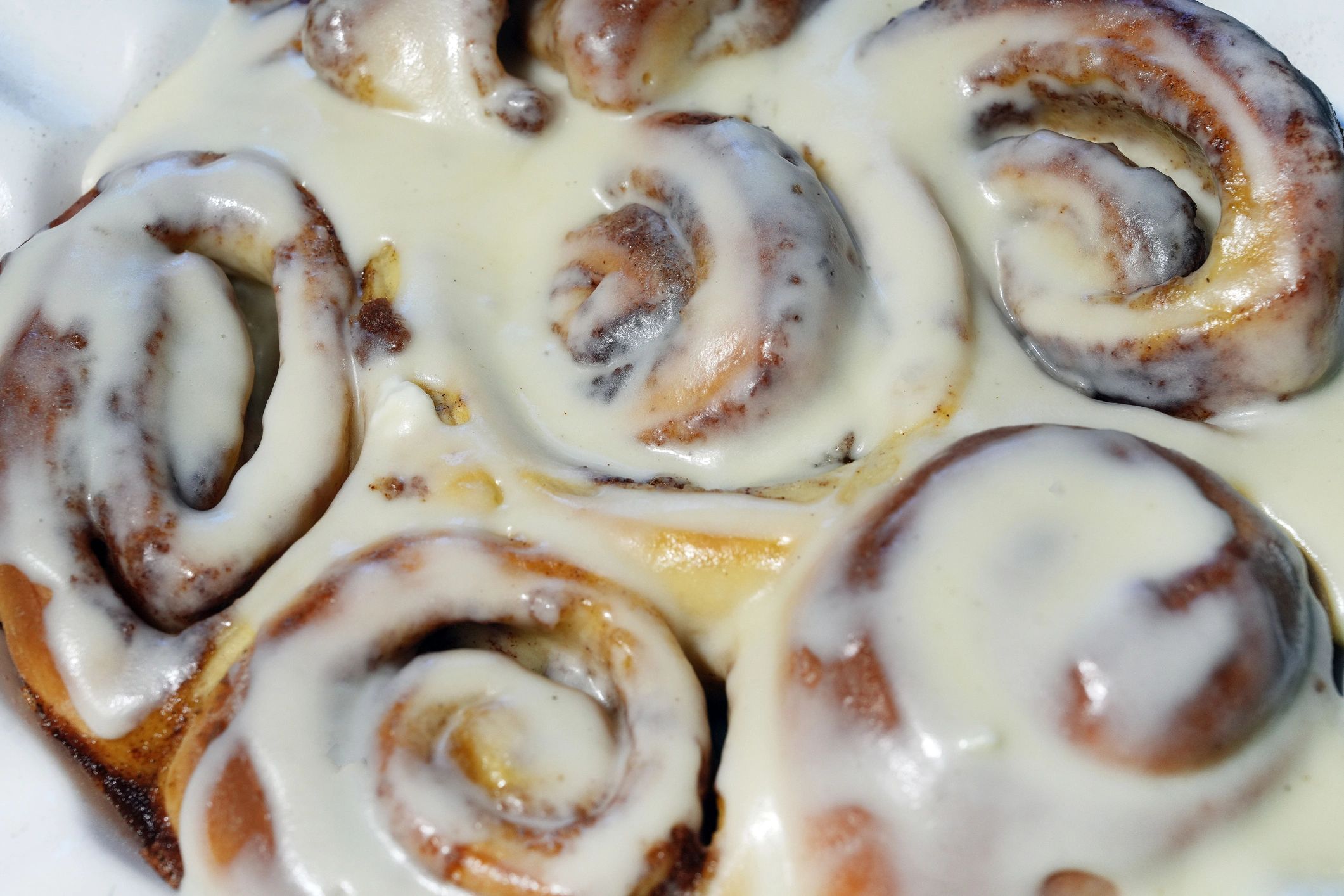 Homemade iced cinnamon buns in a baking dish